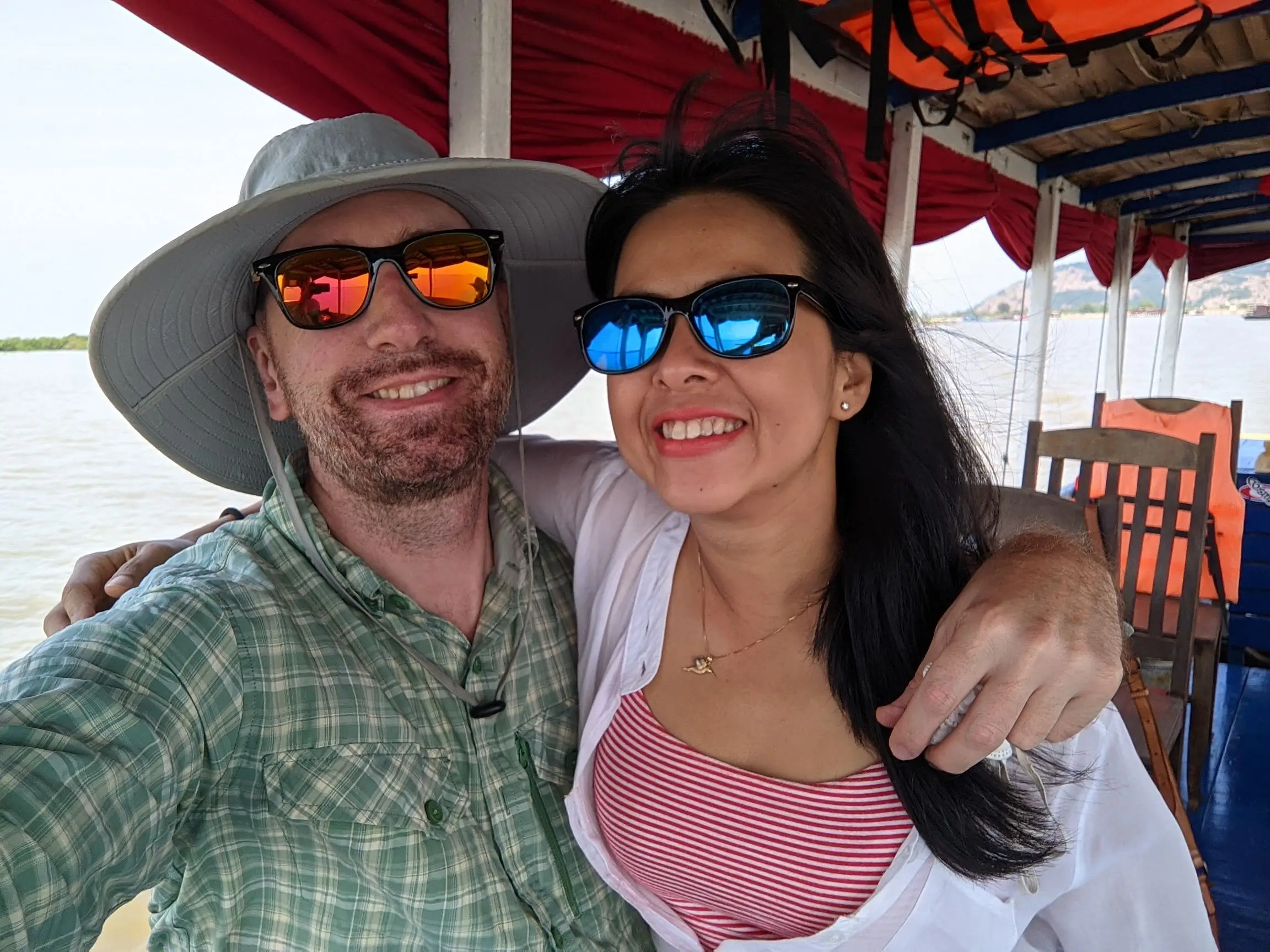jason and daravy boating in cambodia